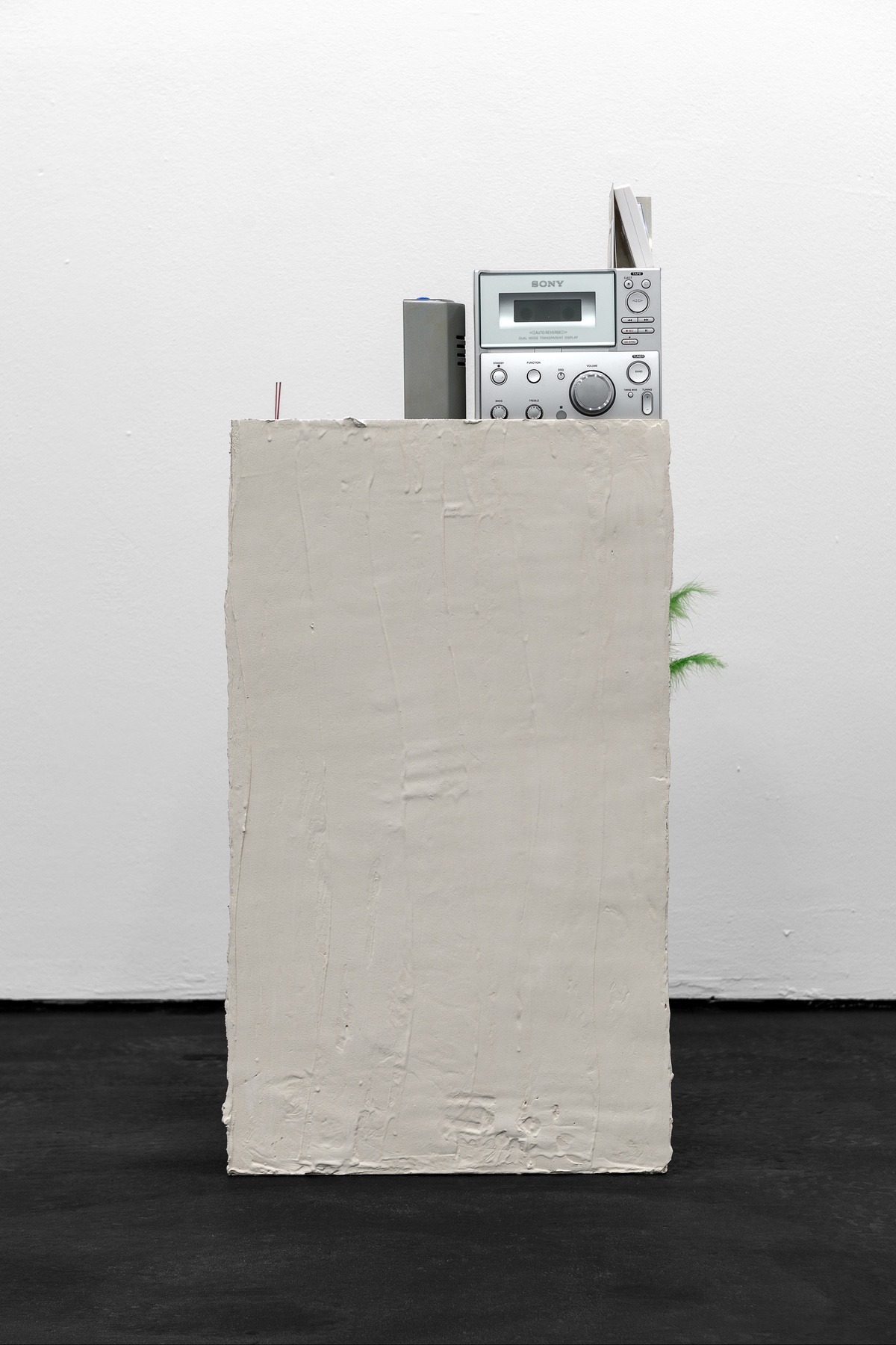 Phung-Tien Phan, City girl, 2022multiplex, putty, acrylic paint, pot, synthetic feathers, scotch tape, bread cutter, stereo system, instax photographs, aluminum plate, incense sticks, LED lamp99 × 42 × 42 cm