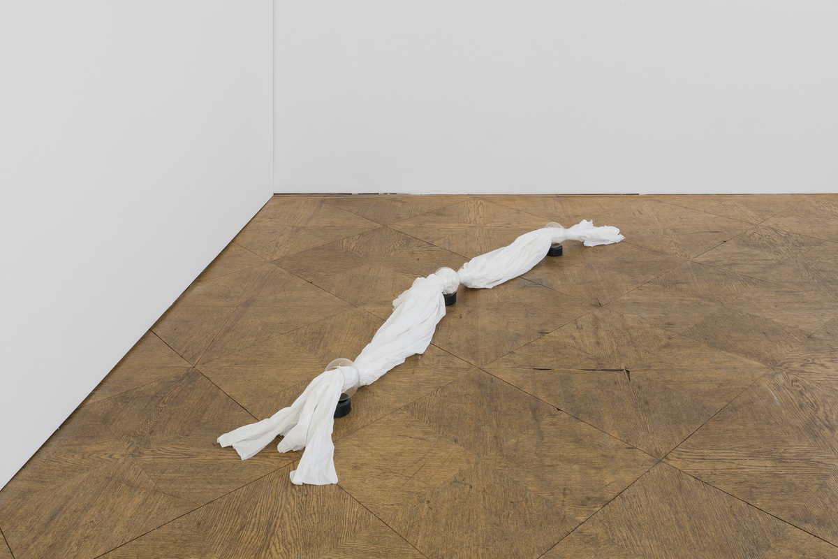 Maria Toumazou, Capture, 2025pre-cut tissues, parts of found mouth-blown candle holders, parts of plastic plotter roll holders180 x 30 x 13 cm