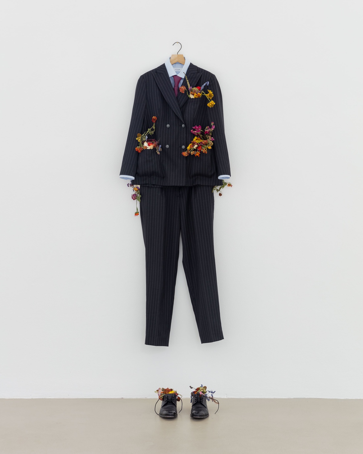 Angharad Williams, My first Suit, 2020custom suit, shirt, tie, shoes, stolen flowers, C-type print, hangerInstallation view from the group exhibition Not Working, 2020, Kunstverein München, Munich, Germany